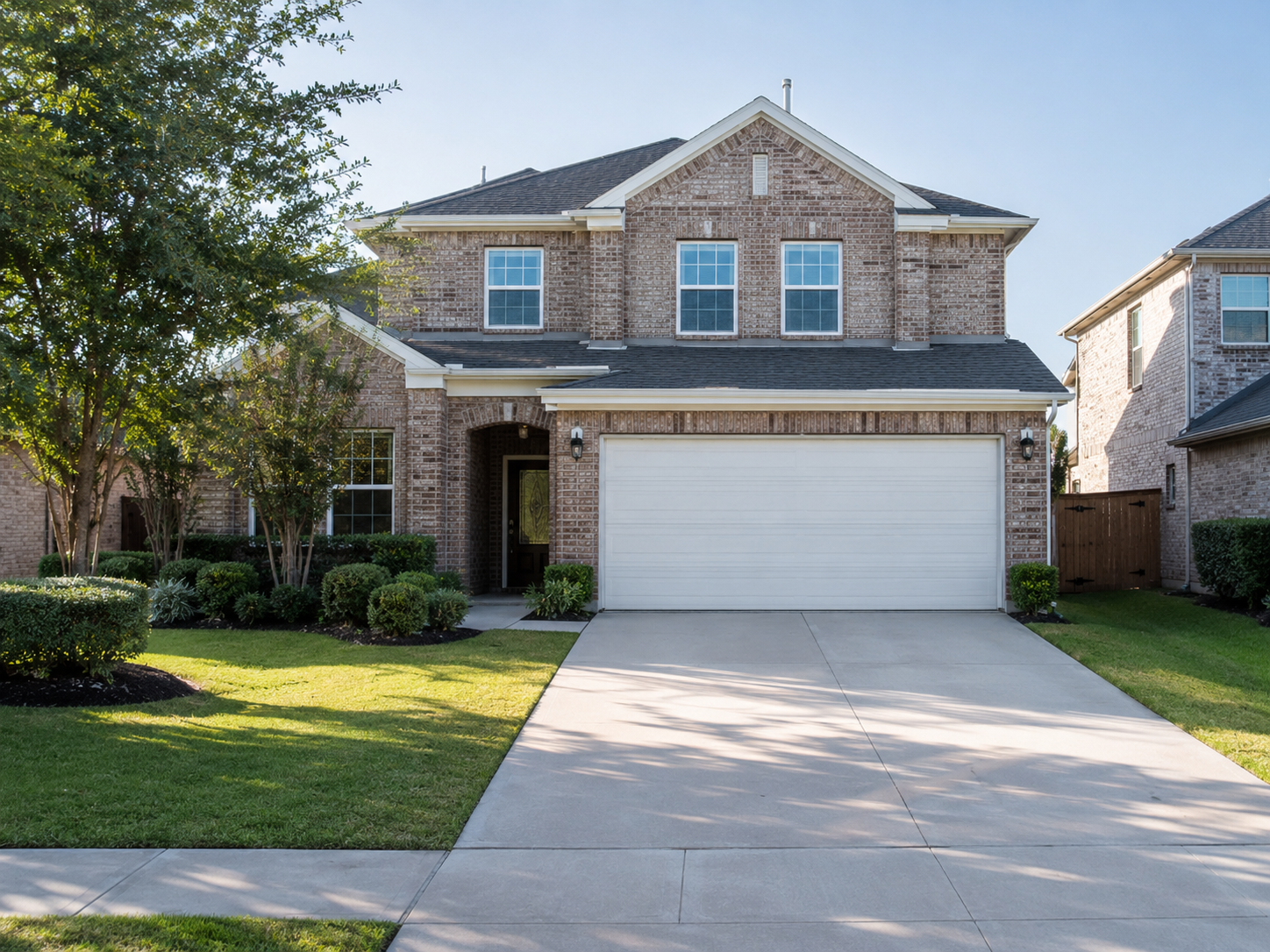 Suburban Round Rock TX home with new white two-car garage door