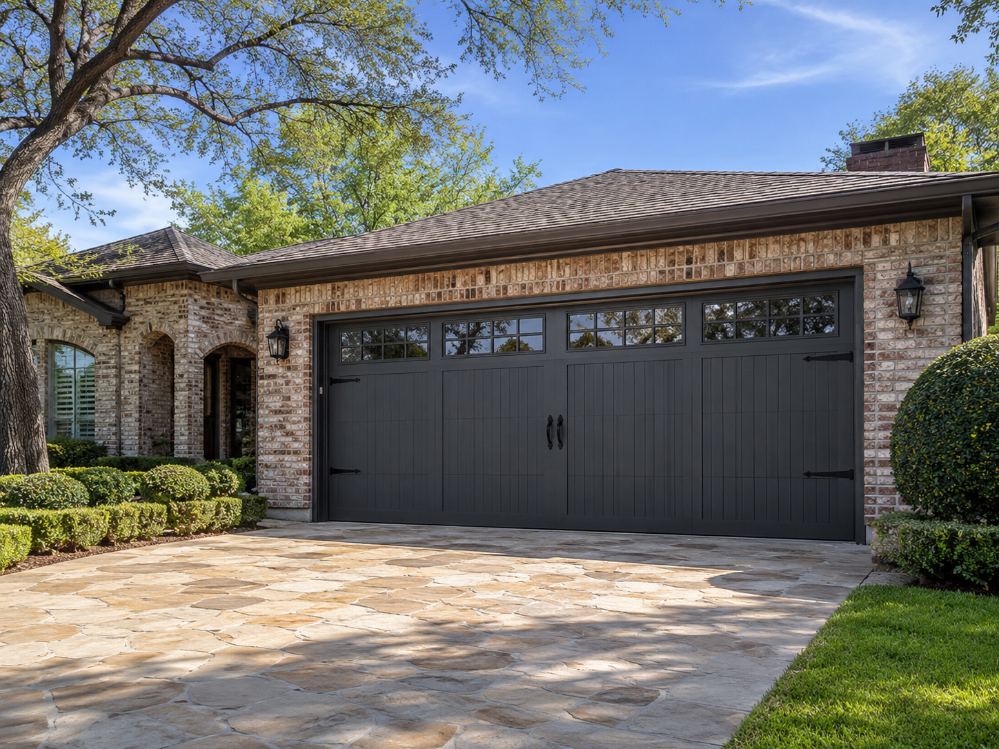 Carriage-style garage door installation on a brick home in Austin TX